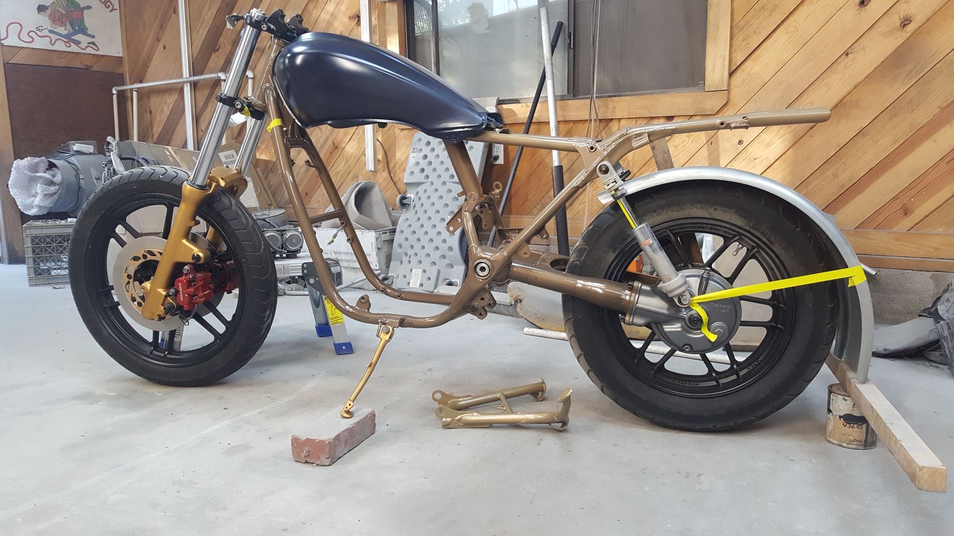 a motorcycle frame with a fuel tank and wheels